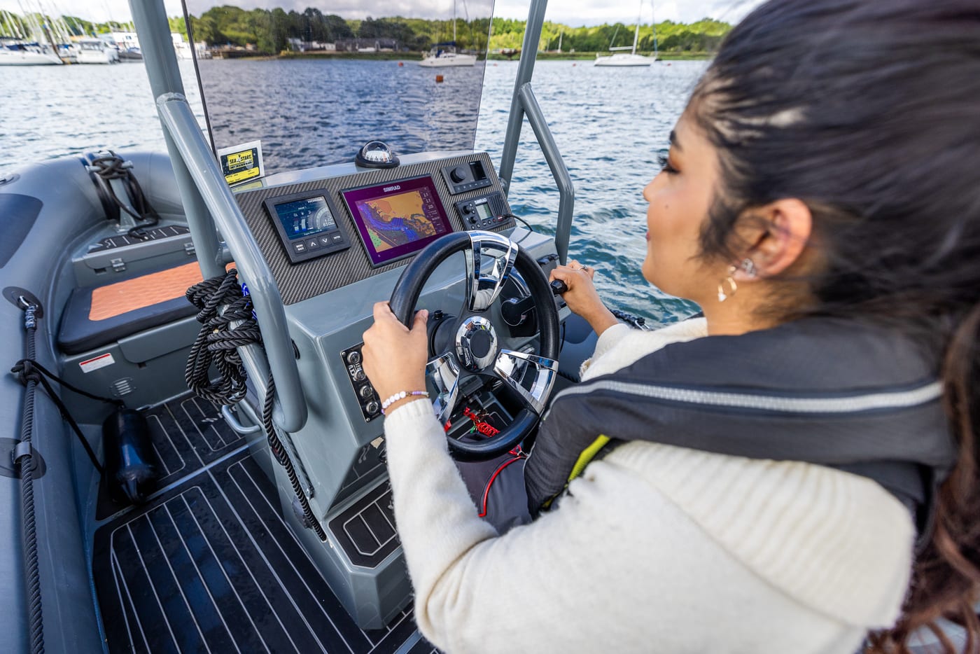 Trainee at the helm of a RIB using the chartplotter on the Solent