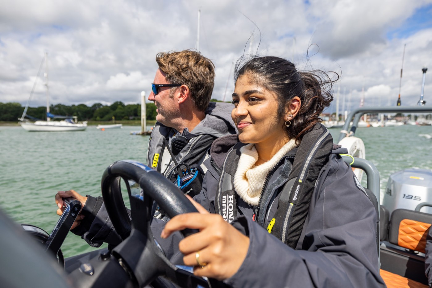 Student helming a RIB on an RYA Powerboat Level 2 course on the Solent with an instructor alongside